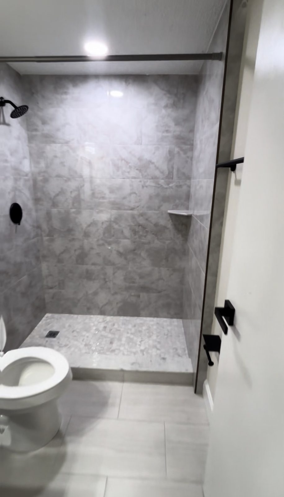 The same bathroom finished with a fully tiled shower